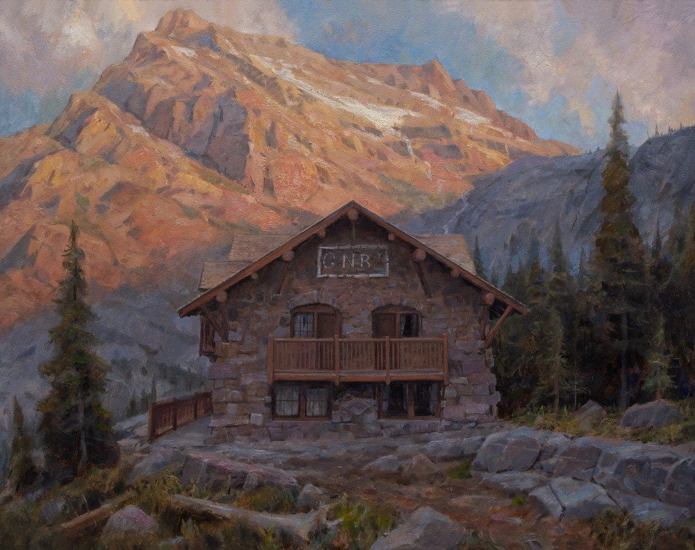 Sperry Chalet, a stone and timber building, stands among mountains and trees.