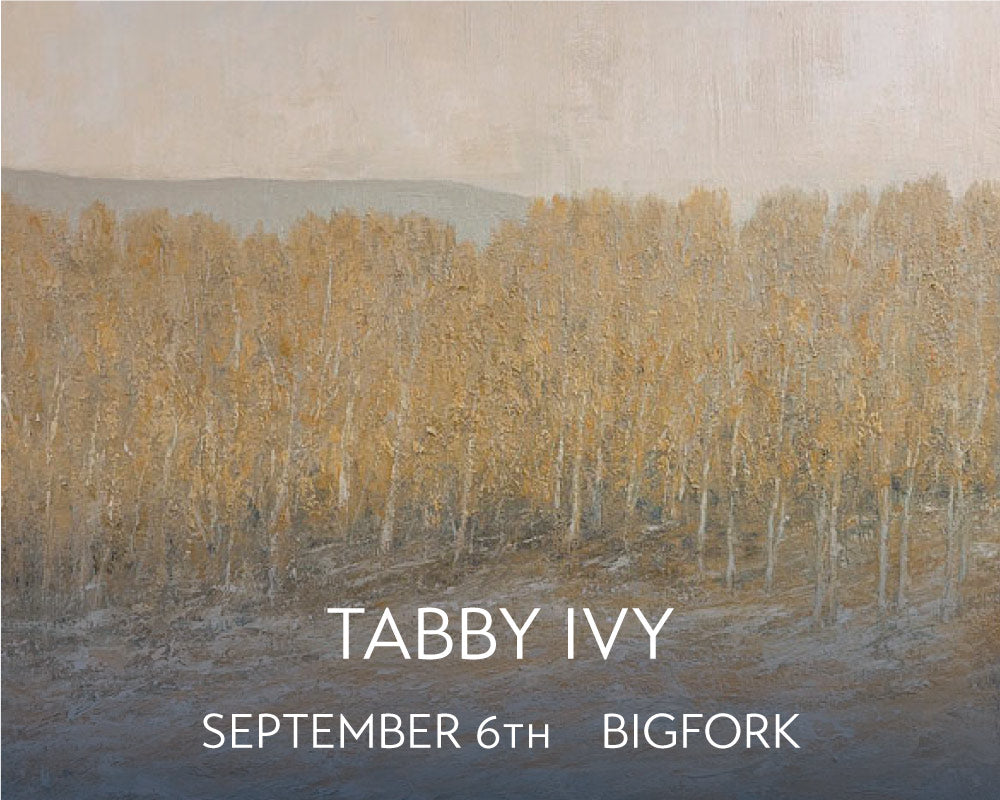 A soft tonalist landscape by Tabby Ivy featuring a forest of aspens in the fall with a dusting of snow in the foreground and the shadow of a mountain peeking above the tree line.